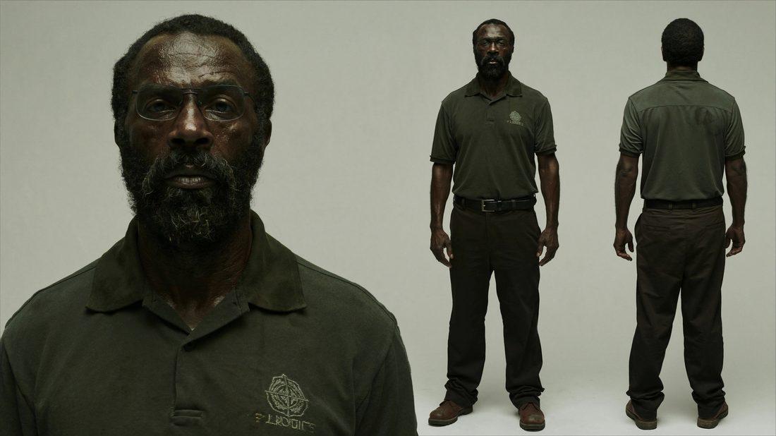 An older bearded man in a worn uniform, standing for a character portrait.